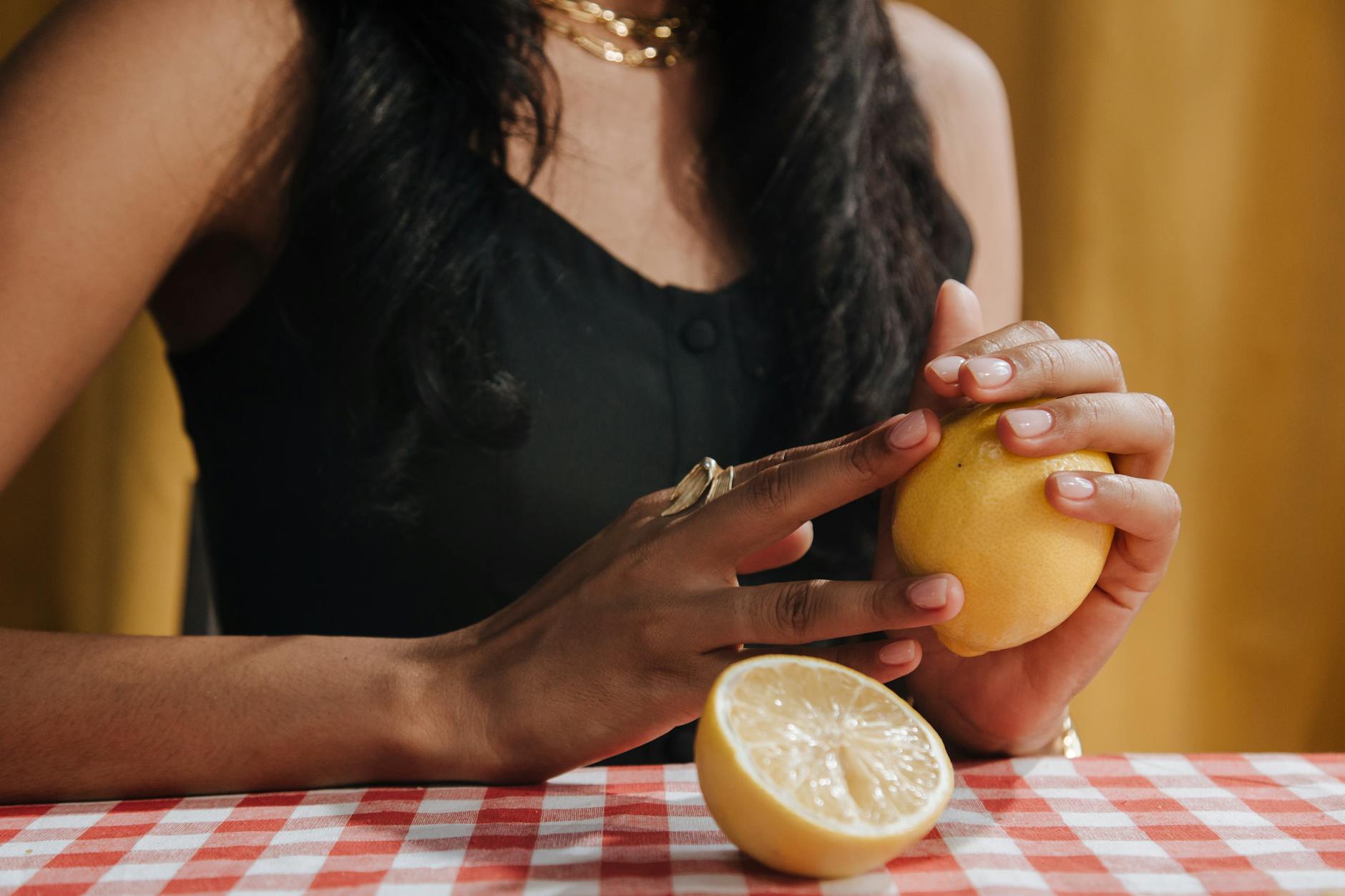 A woman holding a fresh lemon against her body, symbolizing comfort and ease