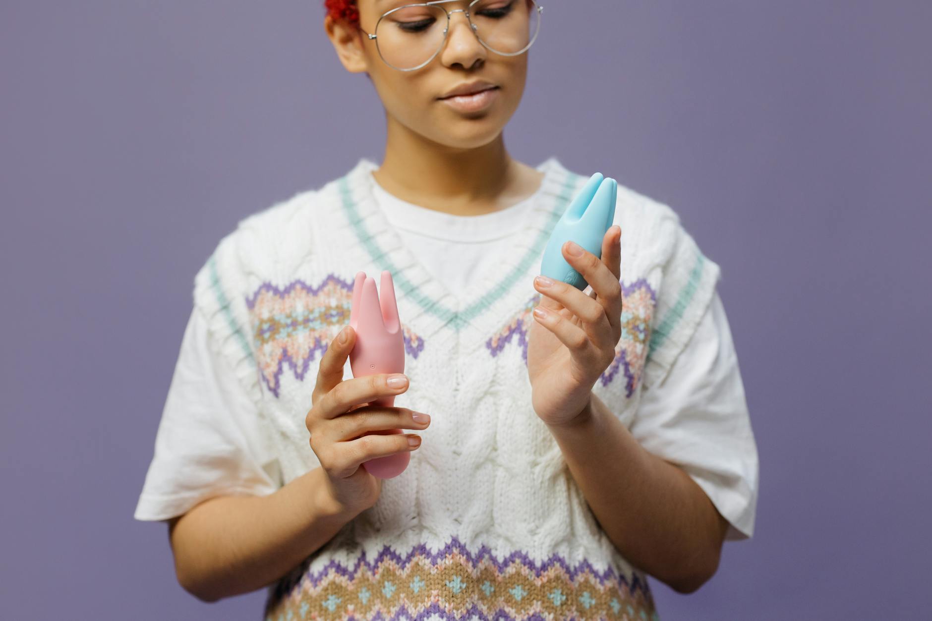 Woman holding a blue clitoral vibrator, contemplating pleasure strategy and recovery time