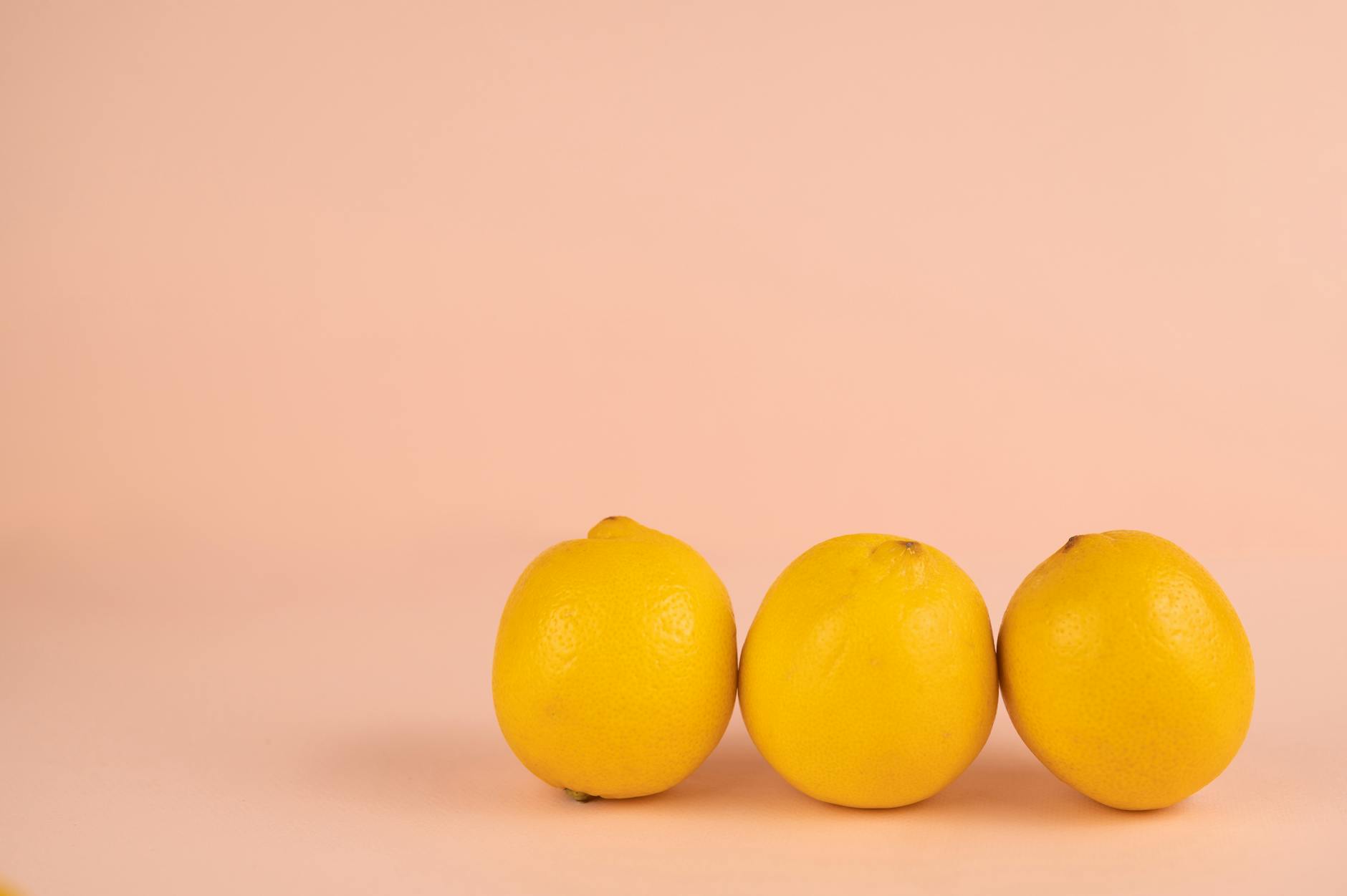 Bright ripe lemons arranged on a pastel background, symbolizing freshness and self-discovery